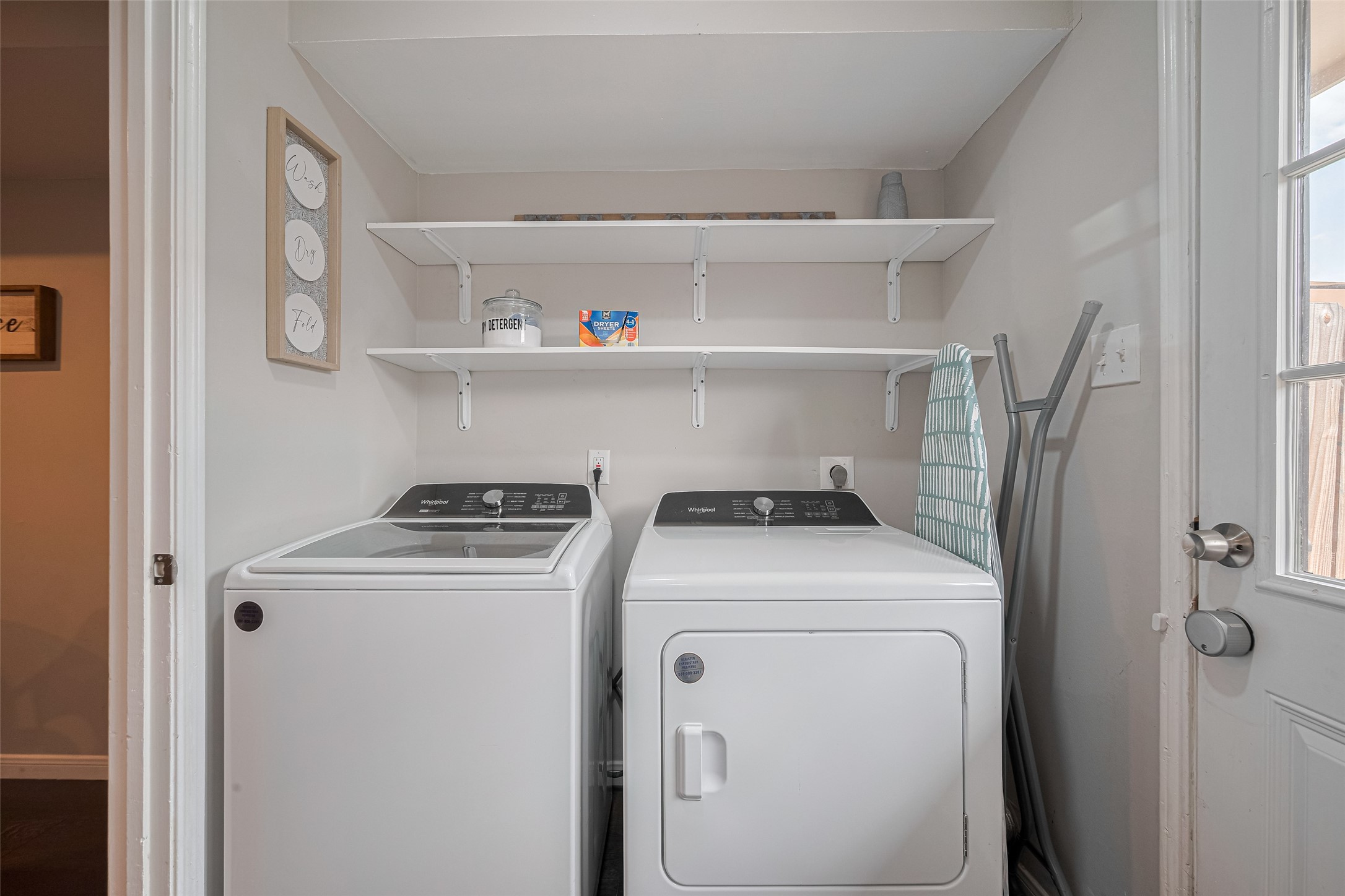 14688 Perthshire Road, Unit C Houston, TX 77079 - Photo 20 of 42 a view of washer and dryer with kitchen in the background