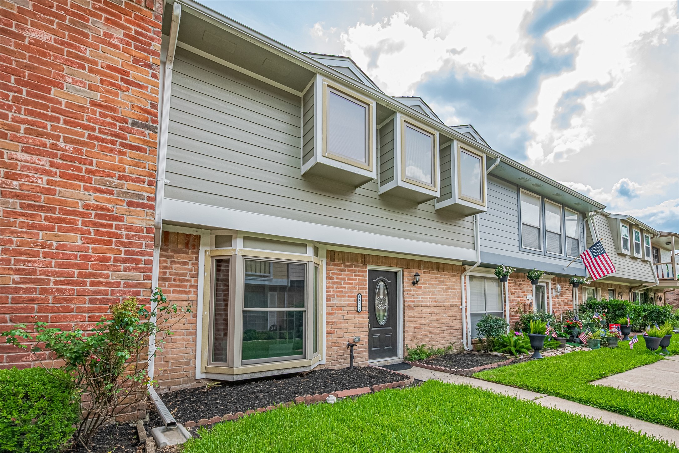 14688 Perthshire Road, Unit C Houston, TX 77079 - Photo 2 of 42 a front view of a house with a garden and plants