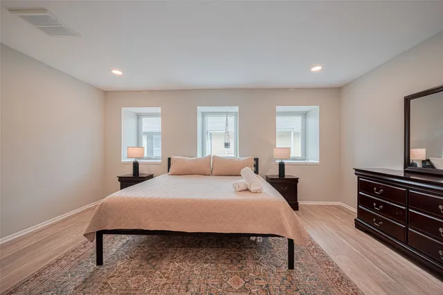 a bedroom with a bed and a dresser