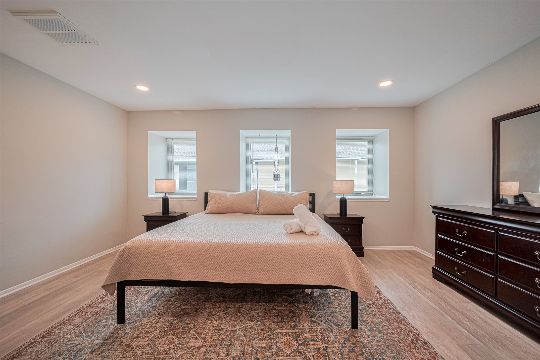 14688 Perthshire Road, Unit C Houston, TX 77079 - Photo 22 of 42 a bedroom with a bed and a dresser