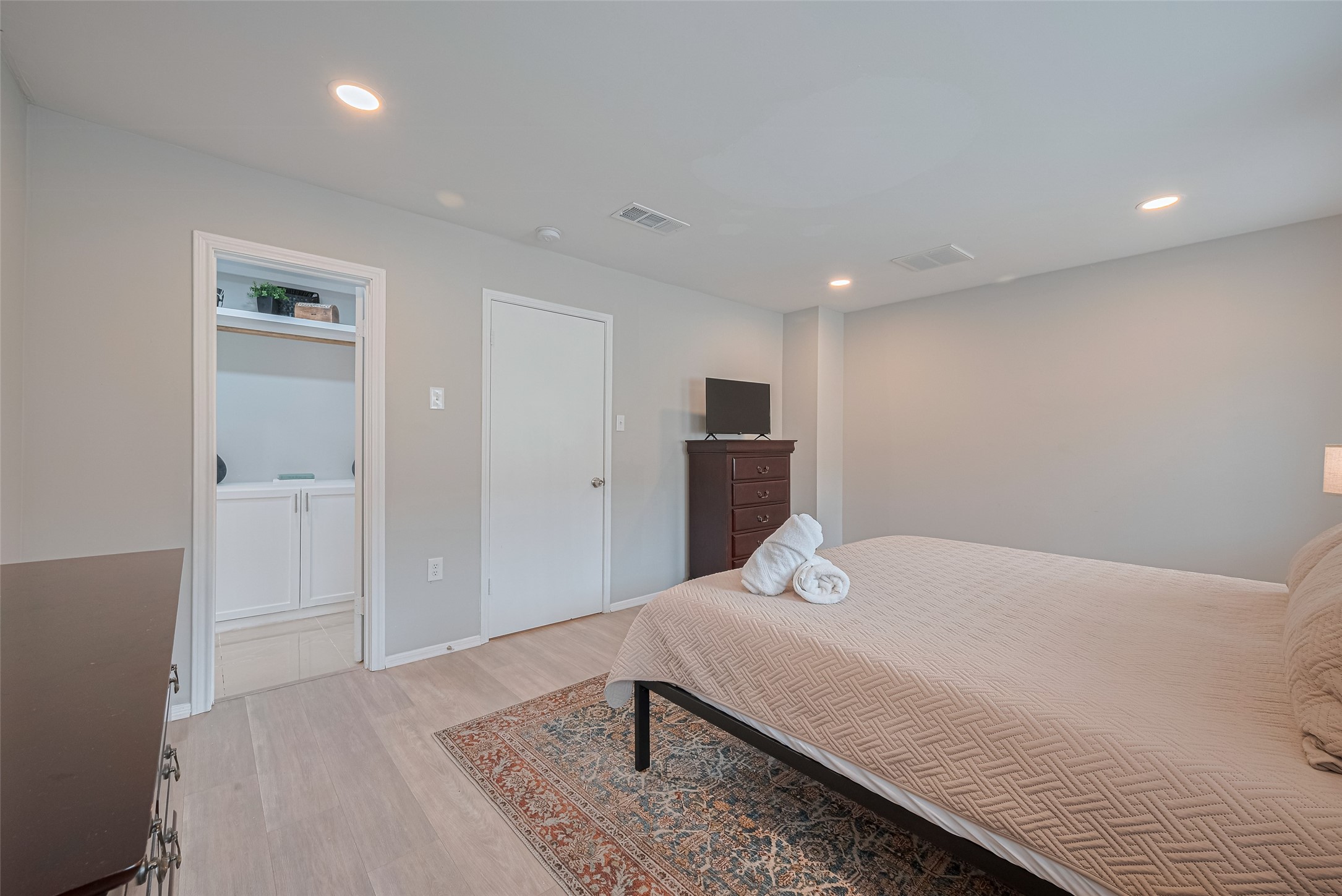 14688 Perthshire Road, Unit C Houston, TX 77079 - Photo 24 of 42 a bedroom with a bed and a night stand