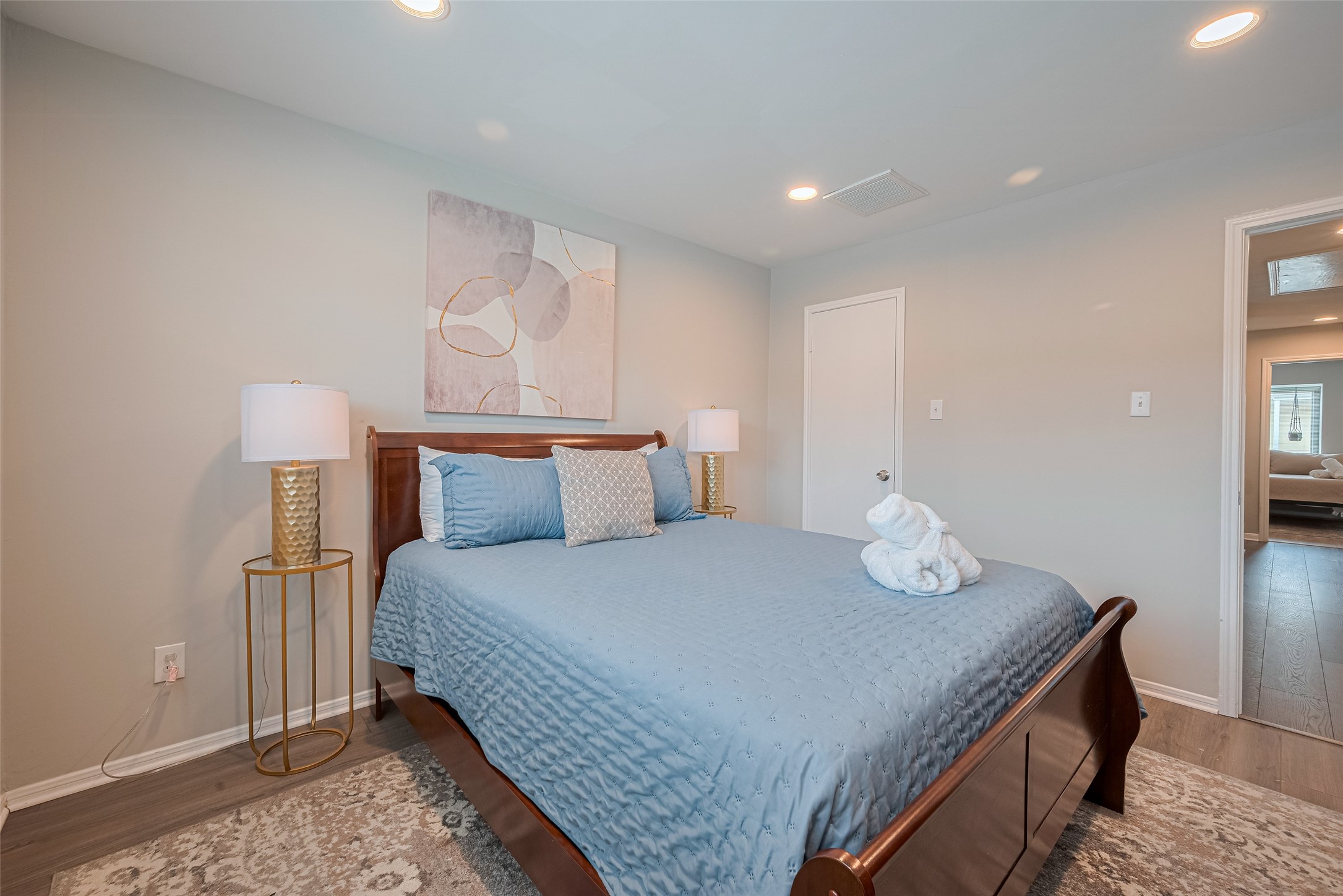 14688 Perthshire Road, Unit C Houston, TX 77079 - Photo 32 of 42 a bedroom with a bed and wooden floor