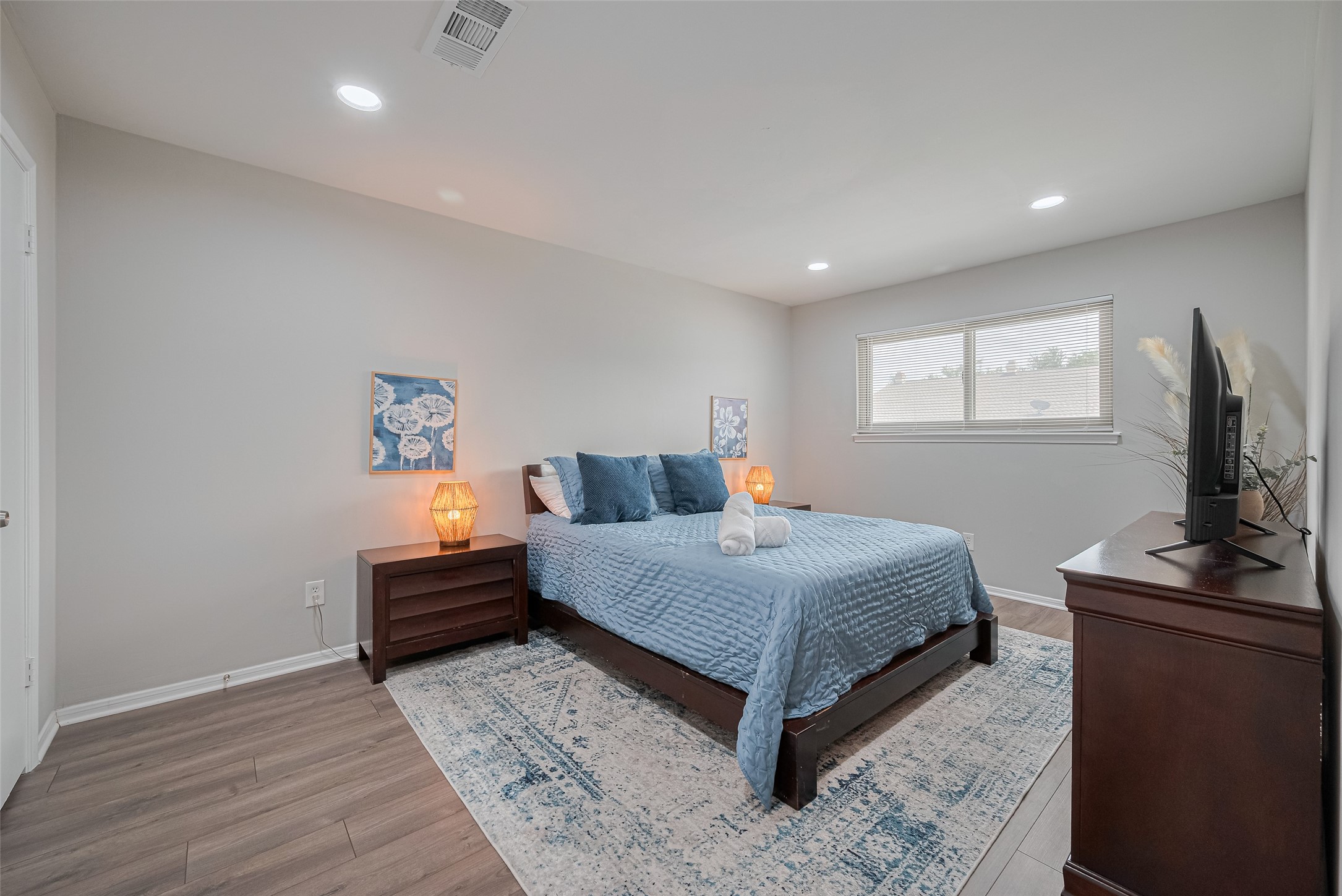 14688 Perthshire Road, Unit C Houston, TX 77079 - Photo 34 of 42 a bedroom with a bed and a flat screen tv