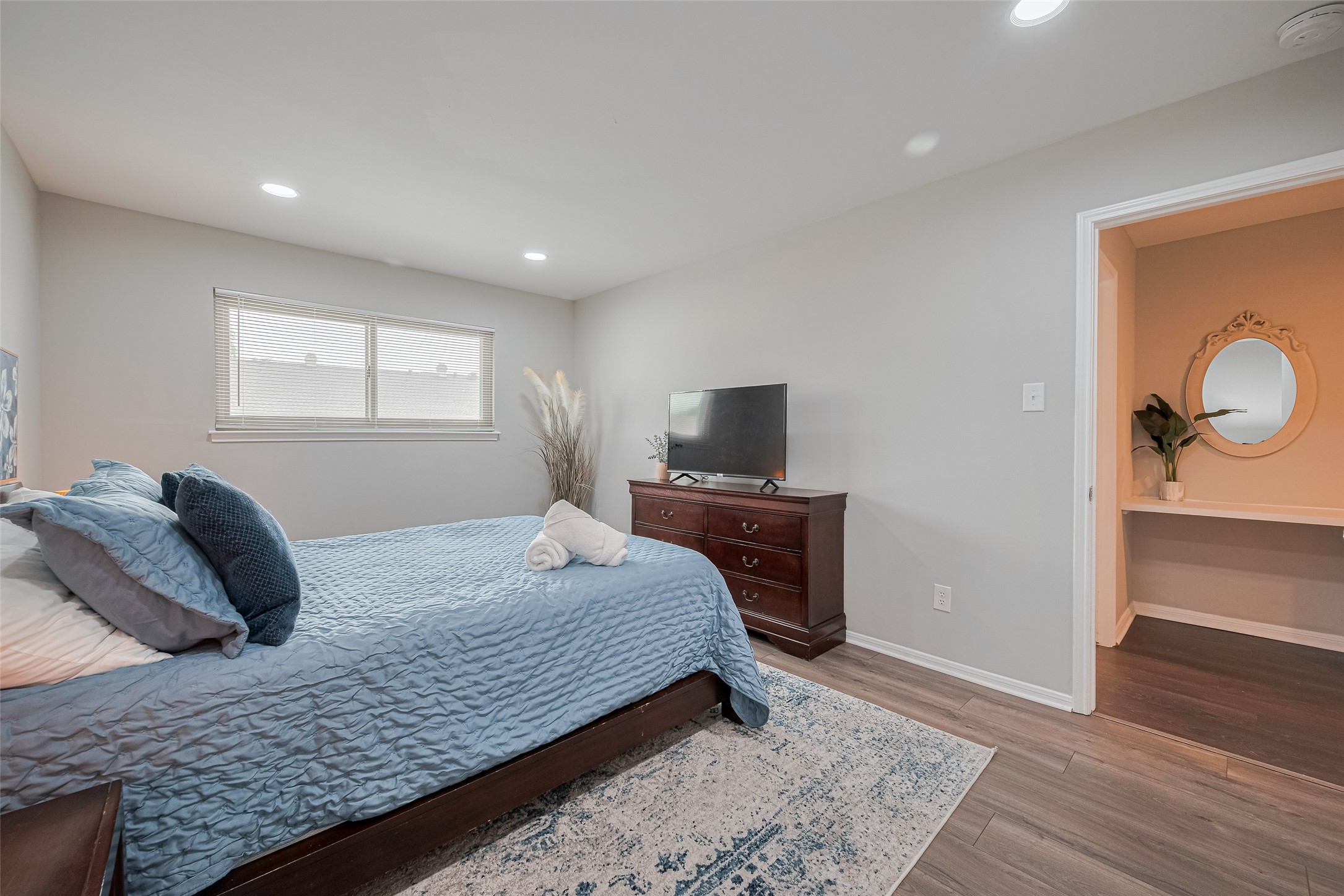 14688 Perthshire Road, Unit C Houston, TX 77079 - Photo 35 of 42 a bedroom with a bed and wooden floor