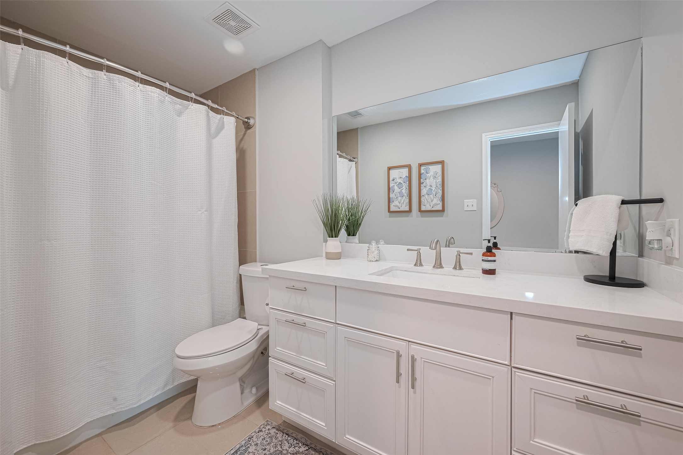 14688 Perthshire Road, Unit C Houston, TX 77079 - Photo 36 of 42 a spacious bathroom with a toilet sink and mirror