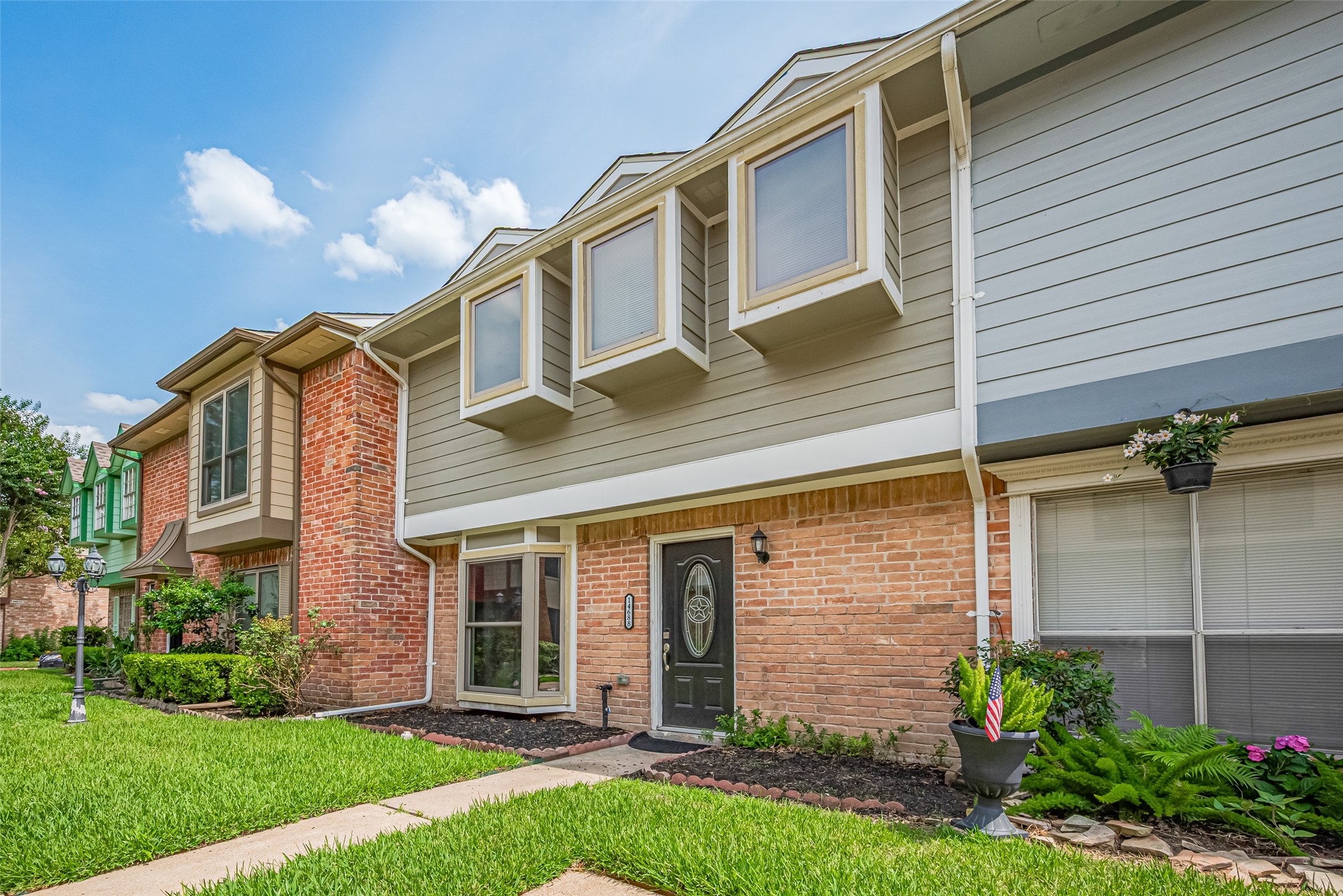 14688 Perthshire Road, Unit C Houston, TX 77079 - Photo 42 of 42 a front view of a house with a garden and yard