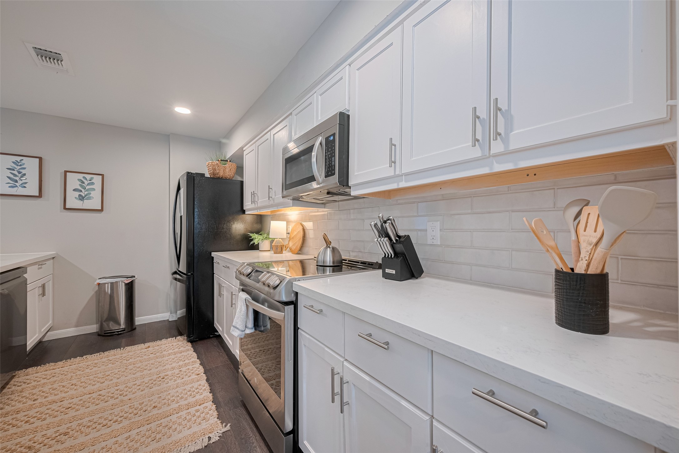 14688 Perthshire Road, Unit C Houston, TX 77079 - Photo 10 of 42 a kitchen with stainless steel appliances granite countertop a sink a stove and a refrigerator