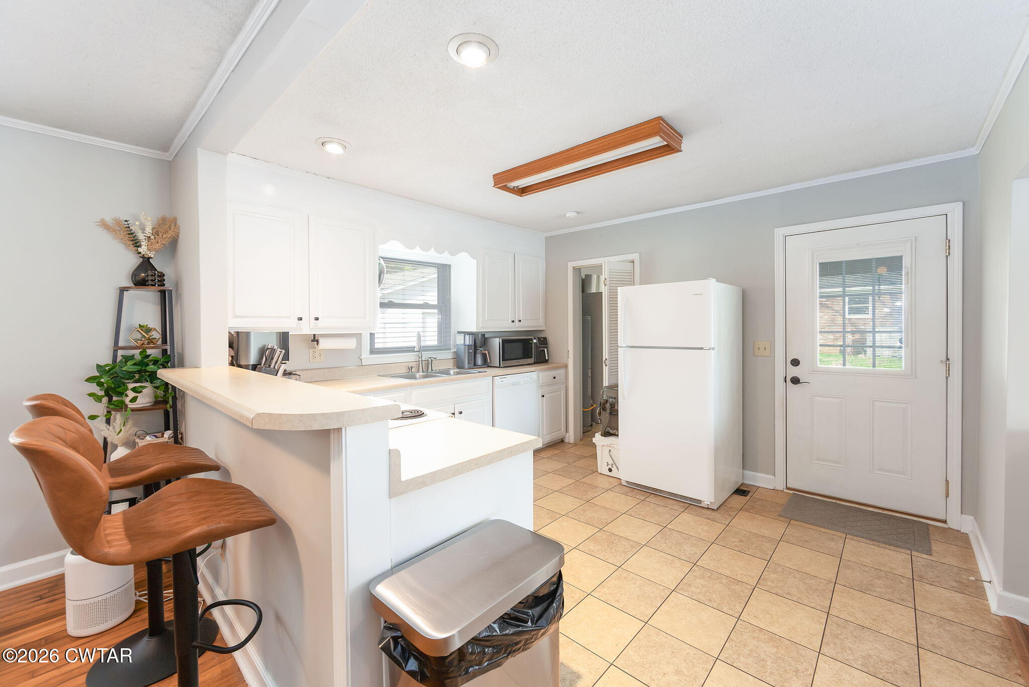 31 Mack Street Jackson, TN 38305 - Photo 11 of 23 a kitchen with a refrigerator and white cabinets