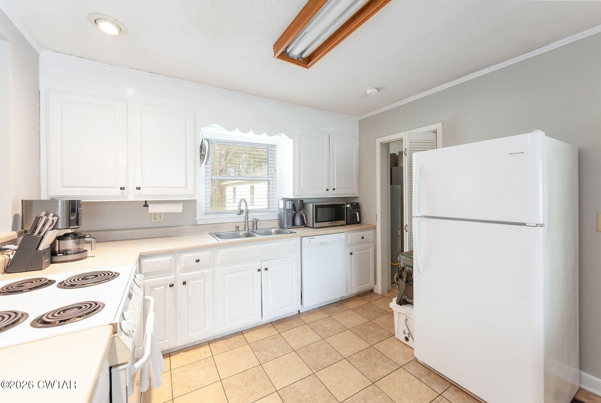 31 Mack Street Jackson, TN 38305 - Photo 12 of 23 a kitchen with a refrigerator sink and cabinets