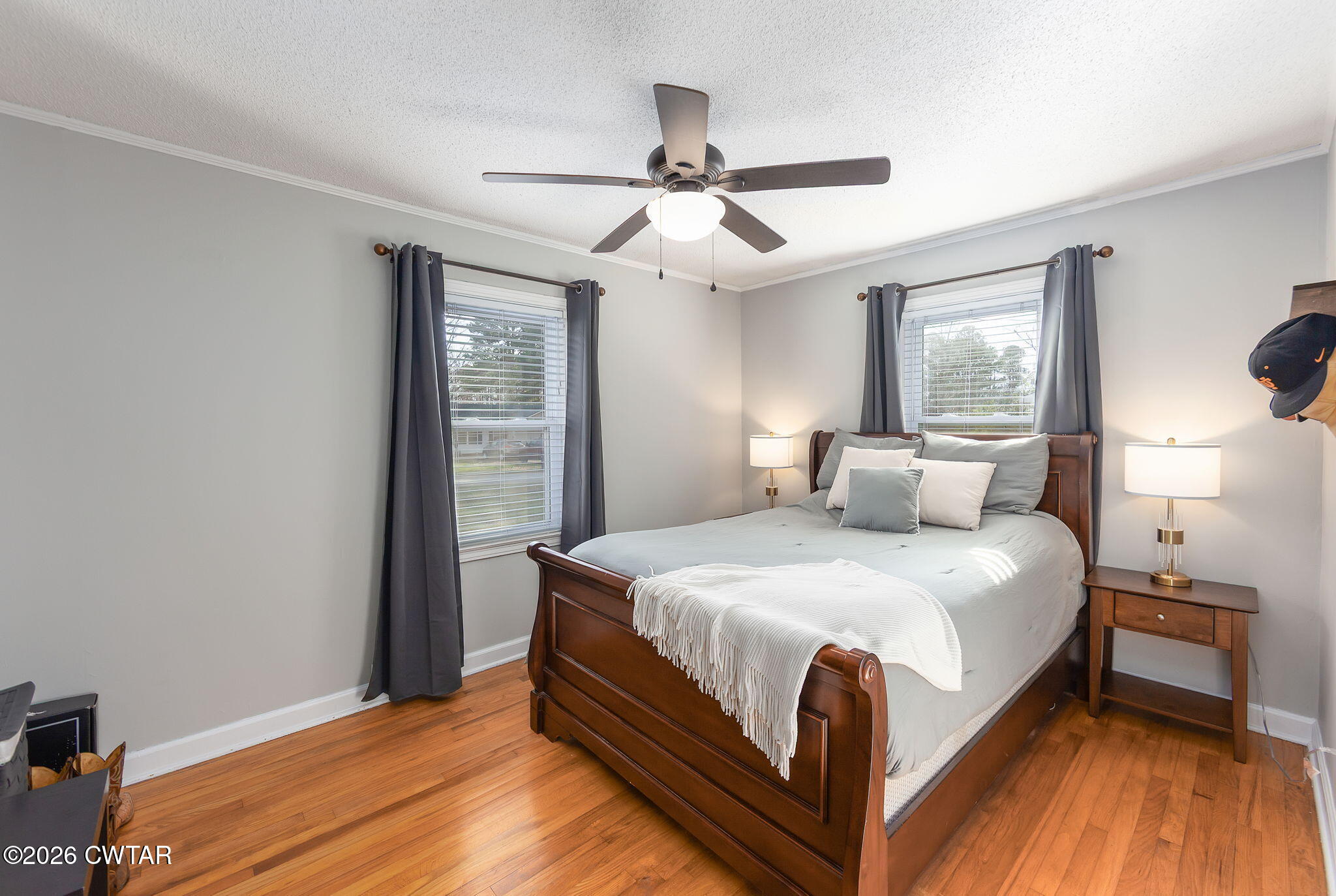 31 Mack Street Jackson, TN 38305 - Photo 18 of 23 a large bed sitting in a bedroom next to a window and a chandelier