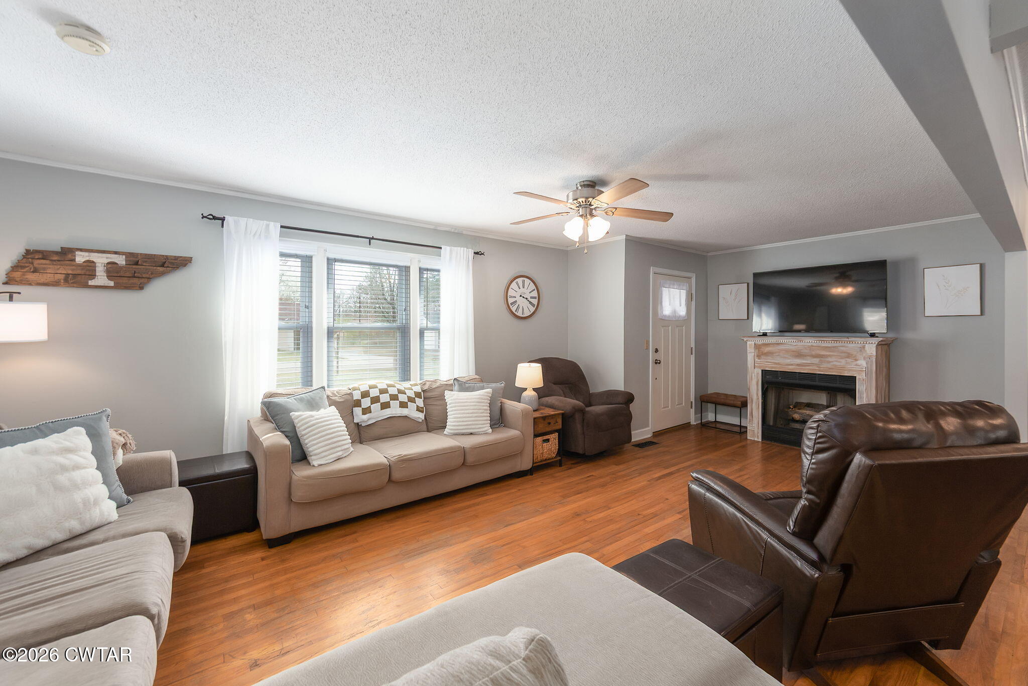 31 Mack Street Jackson, TN 38305 - Photo 4 of 23 a living room with furniture a fireplace and a flat screen tv