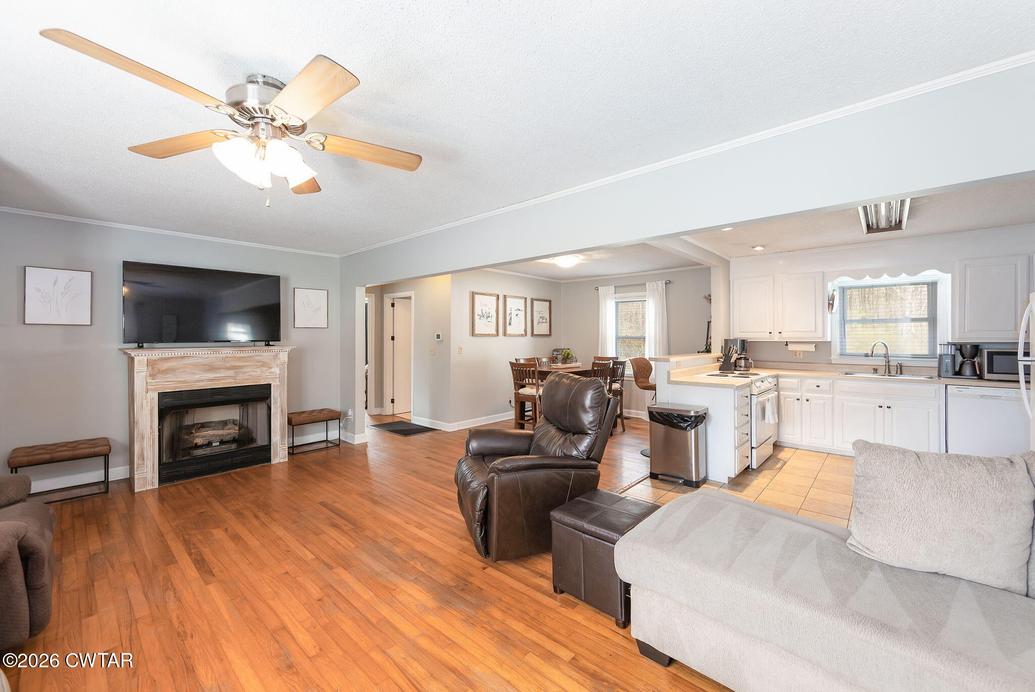 31 Mack Street Jackson, TN 38305 - Photo 7 of 23 a living room with furniture a fireplace and a flat screen tv