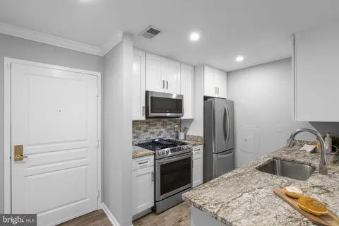 a kitchen with a refrigerator stove and sink
