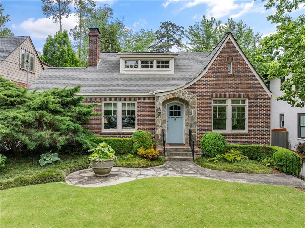 a front view of a house with a yard and porch