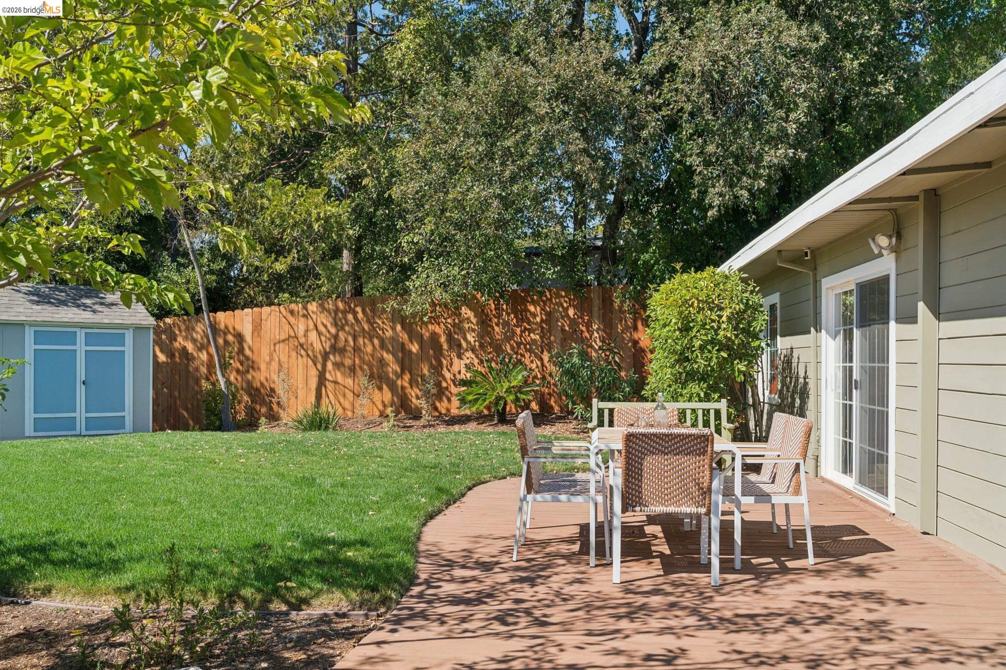1321 Sunset Loop Lafayette, CA 94549 - Photo 33 of 49 Spacious backyard featuring a wood deck, manicured lawn, and privacy fencing
