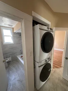a view of a hallway with washer and dryer