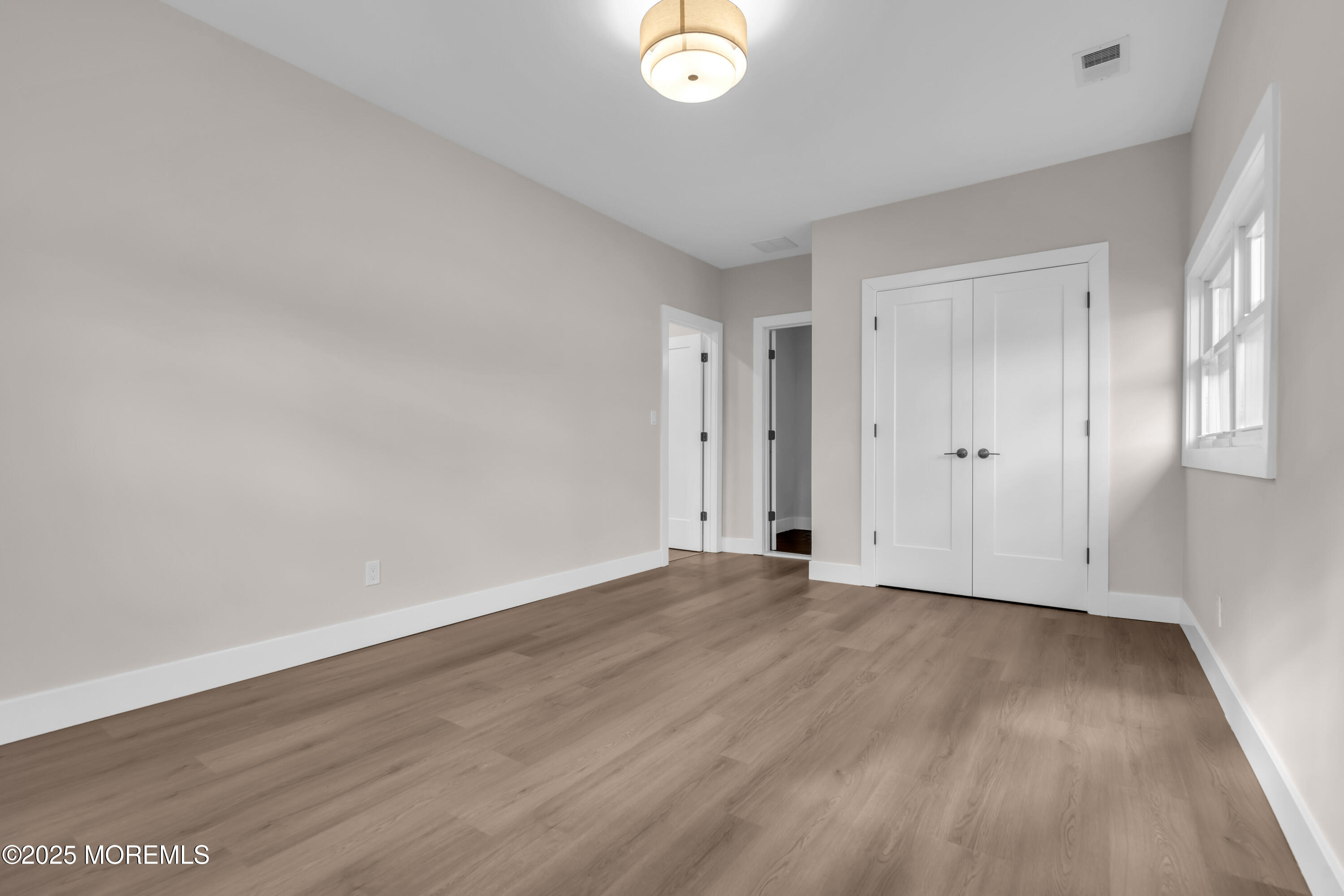 170 Station Road Bayville, NJ 08721 - Photo 29 of 36 a view of an empty room with wooden floor and entryway