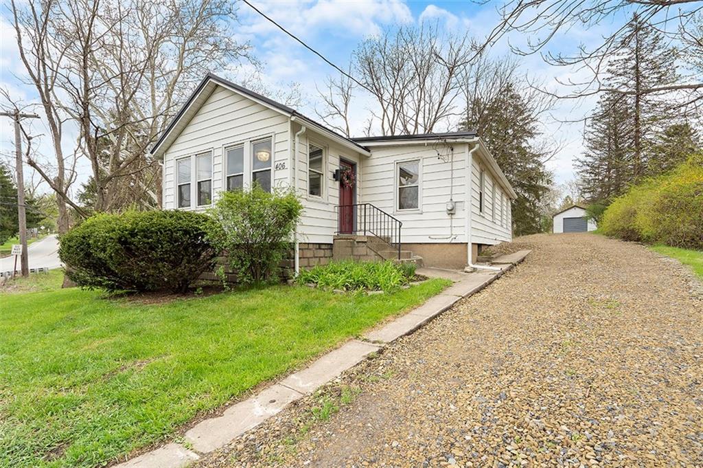 a front view of house with yard and green space