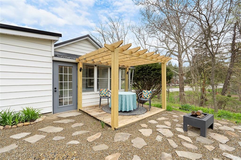 406 Center Road Monroeville, PA 15146 - Photo 4 of 25 a view of a patio with table and chairs near a barn