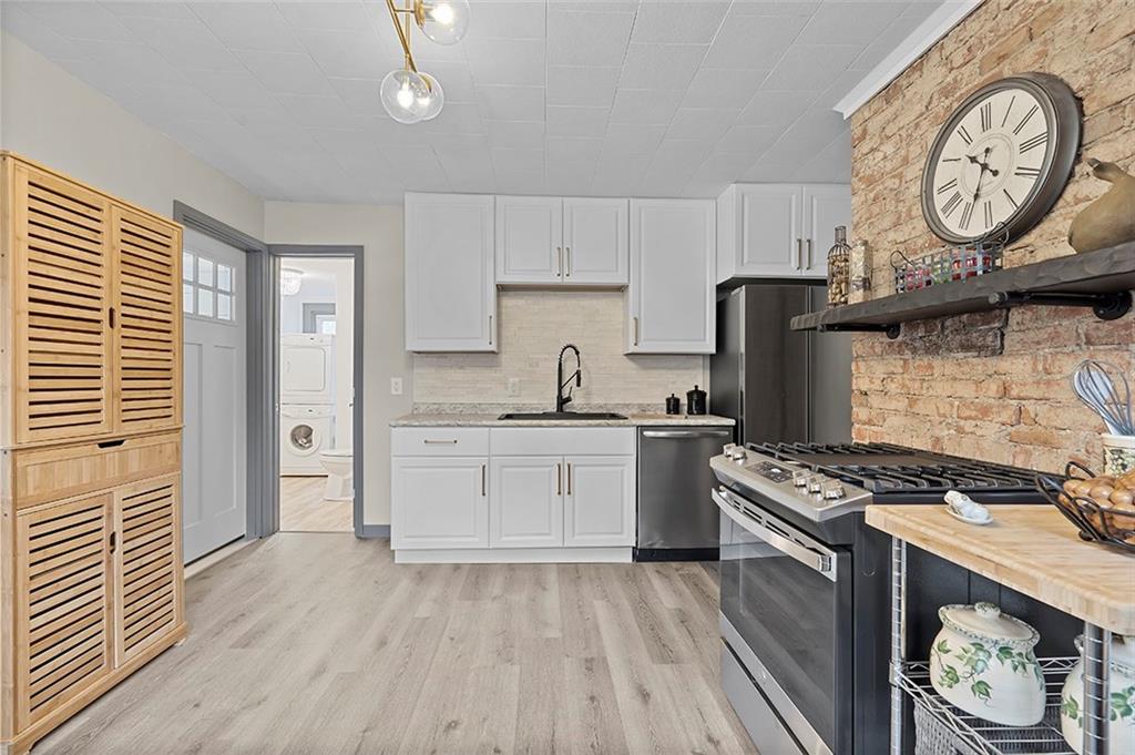 406 Center Road Monroeville, PA 15146 - Photo 7 of 25 a kitchen with a stove a sink and a refrigerator