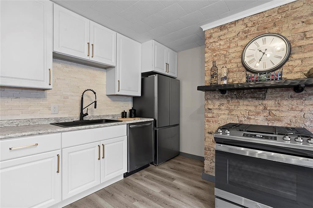 406 Center Road Monroeville, PA 15146 - Photo 10 of 25 a kitchen with granite countertop a stove and a refrigerator