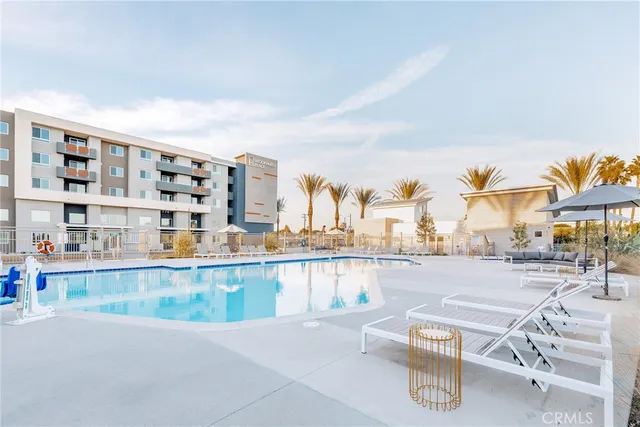 a view of a living room with furniture and a floor to ceiling window