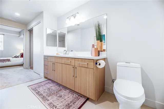 a spacious bathroom with a toilet sink and mirror