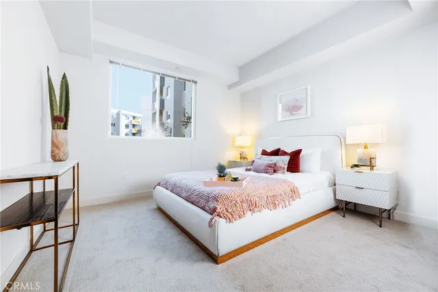 a bedroom with a bed couch and a window