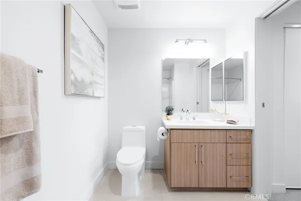 a bathroom with a sink a toilet and mirror