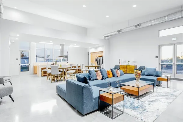 a living room with furniture kitchen view and a table