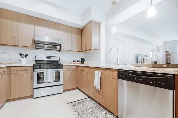 a kitchen with stainless steel appliances granite countertop a sink and cabinets