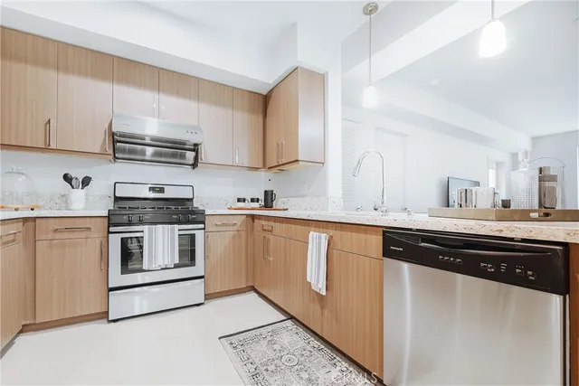 a kitchen with stainless steel appliances granite countertop a sink and cabinets