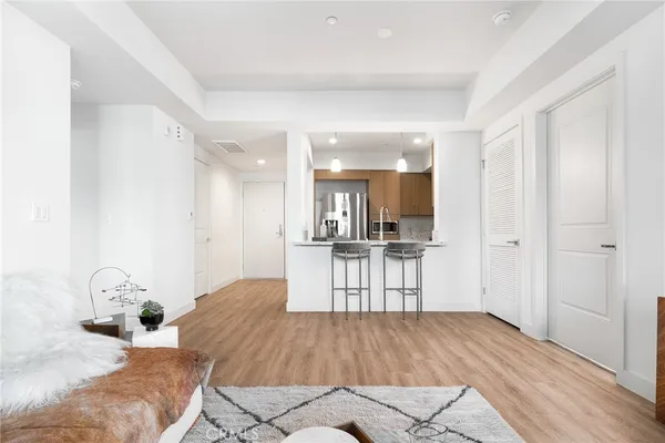 a open kitchen with white cabinets and stainless steel appliances