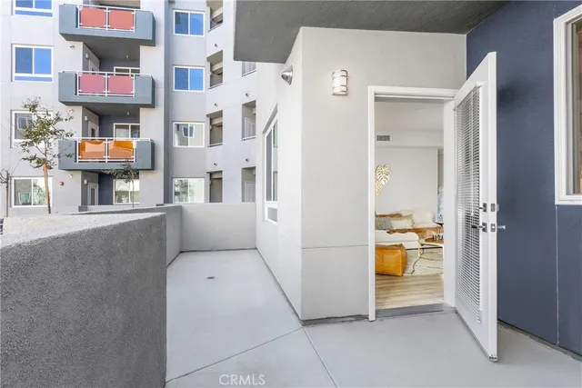 a view of a room that has a bed and a refrigerator