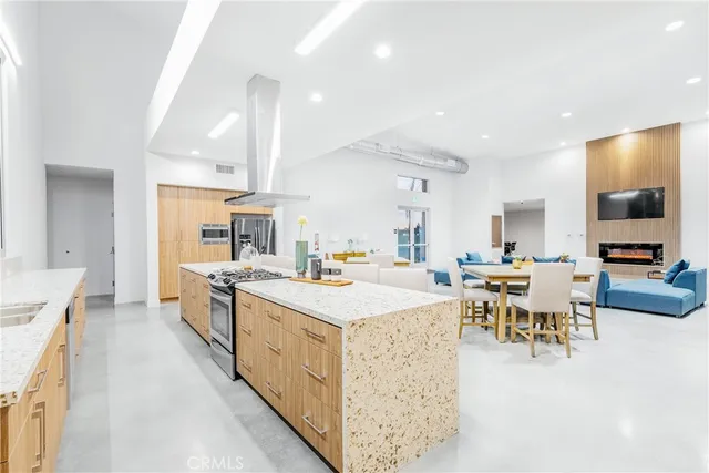 a large kitchen with a table and chairs