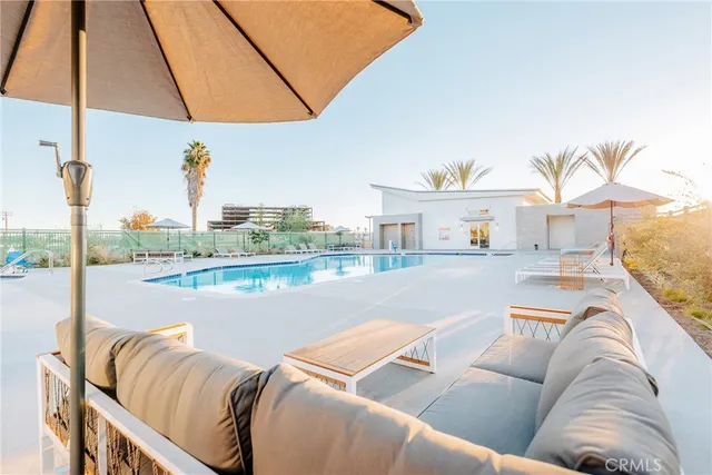 a living room with furniture and a floor to ceiling window