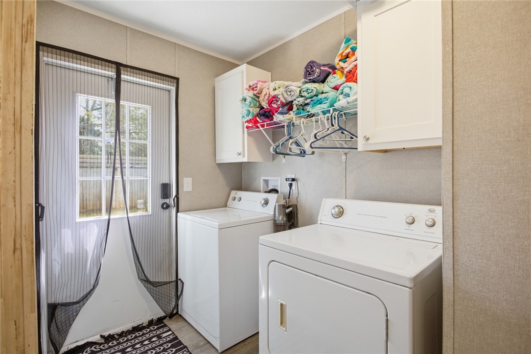 240 Southeast 147 Seneca, SC 29678 - Photo 11 of 27 Functional laundry space with convenient appliances and overhead storage.