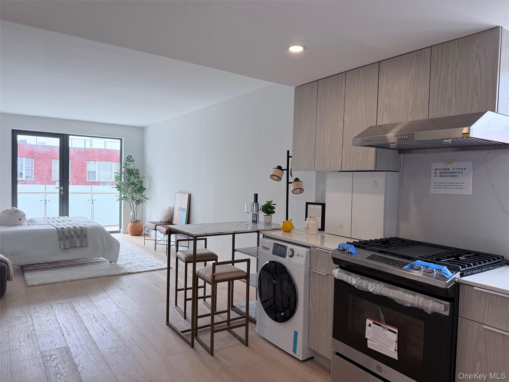 136-80 41st Avenue, Unit 6H Queens, NY 11355 - Photo 2 of 11 a kitchen with a stove a sink and a stove top oven