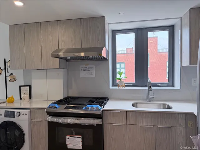 a kitchen with a sink cabinets and window