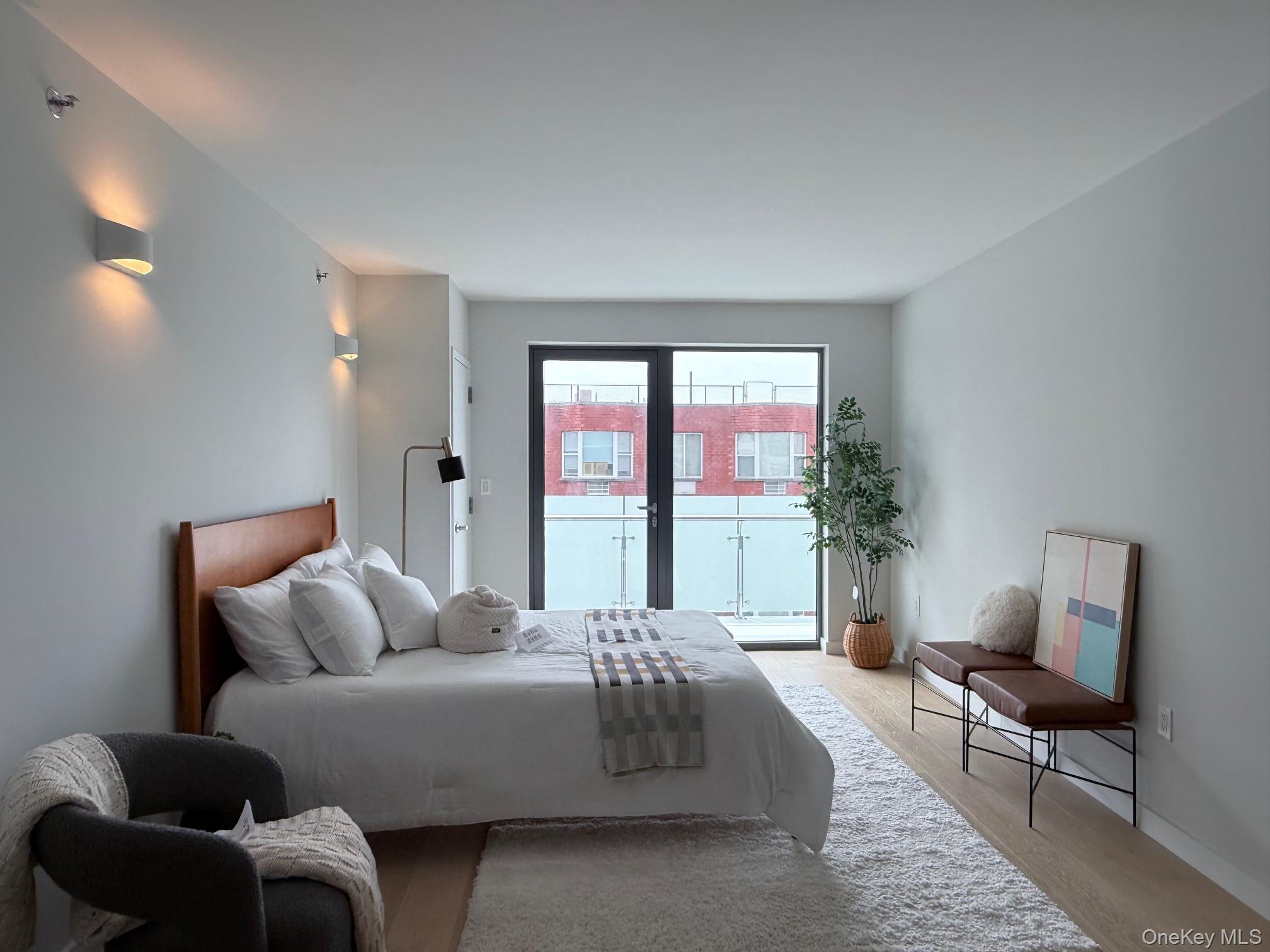 136-80 41st Avenue, Unit 6H Queens, NY 11355 - Photo 6 of 11 a living room with furniture and a large window