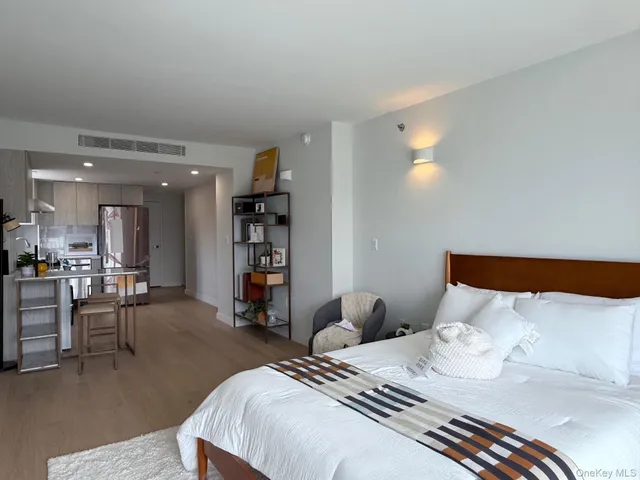 a bedroom with furniture and a wooden floor