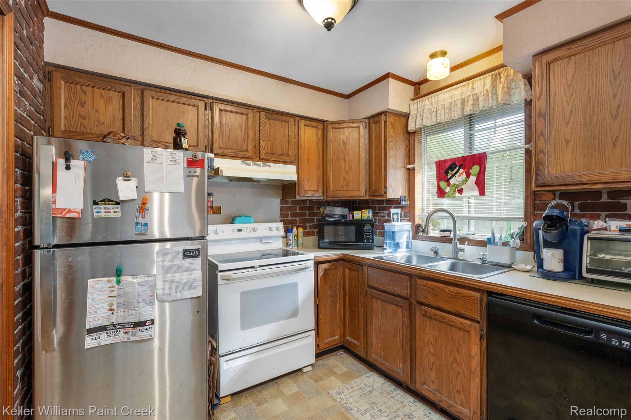 5077 Pinckney Road Howell, MI 48843 - Photo 7 of 39 Kitchen featuring wood-finish cabinetry, a stainless steel refrigerator, and a white electric range