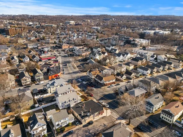 an aerial view of a houses with street