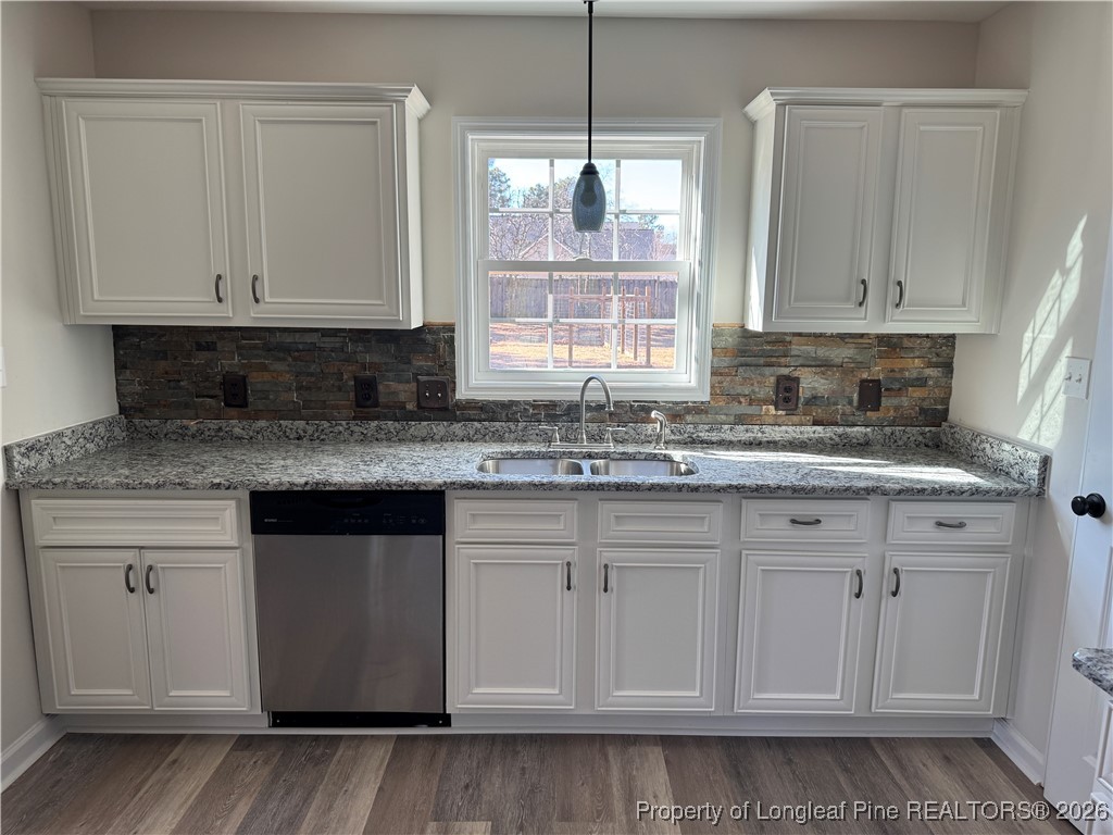 1950 Tingen Road Lillington, NC 27546 - Photo 16 of 50 a kitchen with granite countertop white cabinets white appliances and a sink