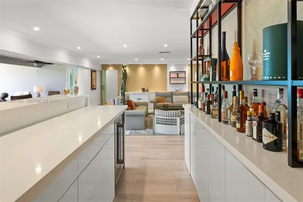 a kitchen with refrigerator cabinets and wooden floor