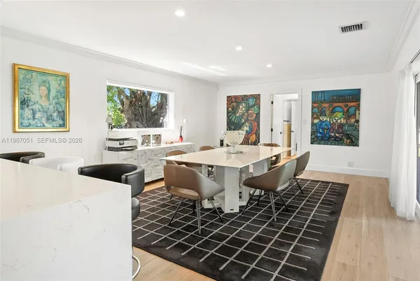 a large living room with stainless steel appliances granite countertop a table and chairs
