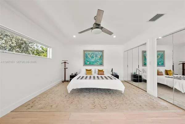 a bedroom with furniture and a flat screen tv