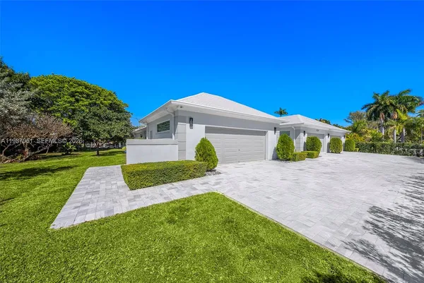 a view of a city with lots of residential buildings ocean and houses in the back