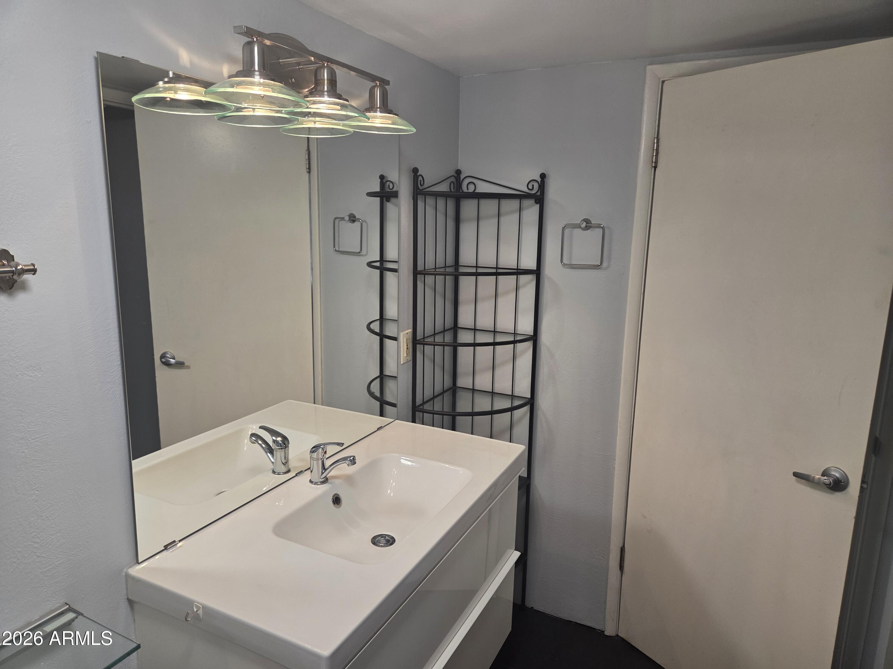 1101 East Bethany Home Road, Unit 7 Phoenix, AZ 85014 - Photo 10 of 14 a bathroom with a sink and mirror
