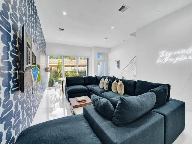 a kitchen with stainless steel appliances granite countertop a refrigerator a sink a stove and a refrigerator